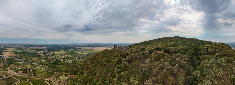 Aerial view of Somlo Castle ruins above vineyards and forests in rural Hungary landscape Aerial view of Somlo Castle ruins above vineyards and forests in rural Hungary landscape