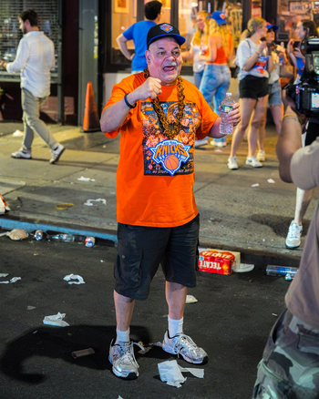 Williamsburg Brooklyn New York USA 14 June 2026 View of a fan celebrating the New York Knicks NBA championship victory wearing an orange team shirt on a street. Williamsburg Brooklyn New York USA 14 June 2026 View of a fan celebrating the New York Knicks NBA championship victory wearing an orange team shirt on a street.