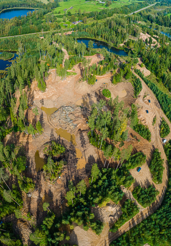 Aerial view of a sand quarry surrounded by dense pine forests and small lakes in Latvia. Aerial view of a sand quarry surrounded by dense pine forests and small lakes in Latvia.