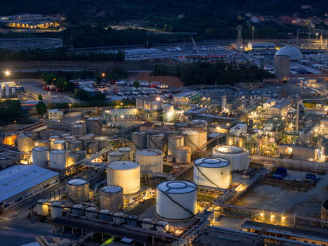 Aerial view of the plant for the production of finished lubricants with illuminated storage tanks and industrial infrastructure at night in Vado Ligure Liguria Italy. Aerial view of the plant for the production of finished lubricants with illuminated storage tanks and industrial infrastructure at night in Vado Ligure Liguria Italy.