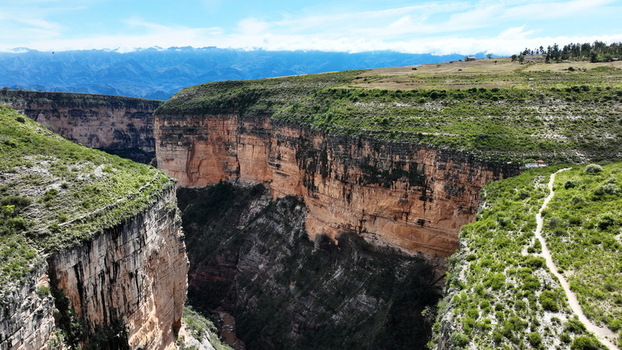 Aerial view of El Vergel canyon featuring steep rock walls lush green vegetation and a winding trail in Torotoro Potosi Department Bolivia. Aerial view of El Vergel canyon featuring steep rock walls lush green vegetation and a winding trail in Torotoro Potosi Department Bolivia.