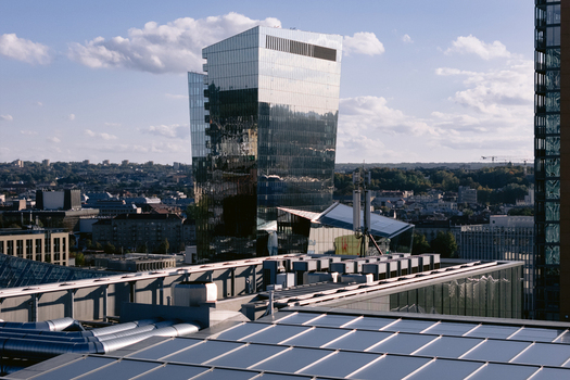 Aerial view of a modern glass skyscraper in the business district of Vilnius Vilnius County Lithuania.
