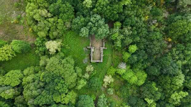 Aerial view of Forno da Santa ruins in a dense forest Spain.