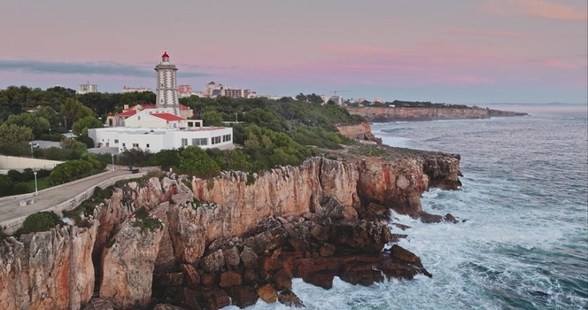 Aerial view of the Santa Marta Lighthouse perched on rugged cliffs overlooking the Atlantic Ocean at sunset in Lisbon Lisbon Portugal. Aerial view of the Santa Marta Lighthouse perched on rugged cliffs overlooking the Atlantic Ocean at sunset in Lisbon Lisbon Portugal.