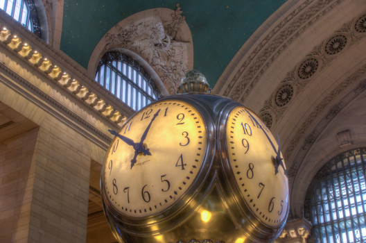 New York City USA View of the iconic four faced opal clock at the information stand inside the main concourse of Grand Central Terminal. New York City USA View of the iconic four faced opal clock at the information stand inside the main concourse of Grand Central Terminal.