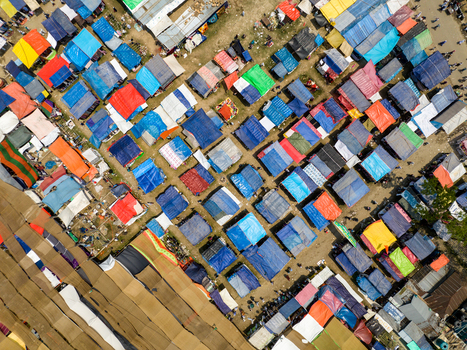 Aerial view of a patchwork of colorful shelters clustered tightly a vibrant yet dense settlement sprawling Charmonai Barisal Division Bangladesh. Aerial view of a patchwork of colorful shelters clustered tightly a vibrant yet dense settlement sprawling Charmonai Barisal Division Bangladesh.