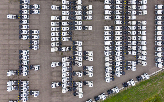 Aerial view of rows of parked semi trucks in a large logistics depot in Son Noord Brabant Netherlands.