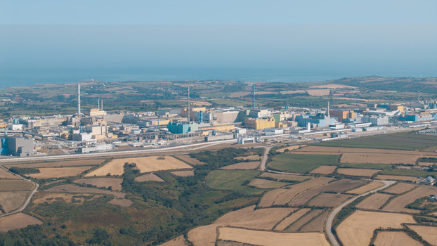 Aerial view of the La Hague nuclear reprocessing plant with its industrial facilities and chimneys situated along the coastline in La Hague Normandie France.