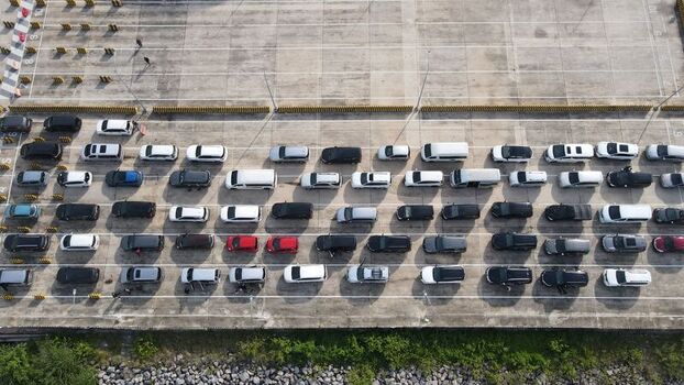 Aerial view of the Bakauheni ferry terminal parking area with rows of vehicles waiting for boarding in Bakauheni Lampung Indonesia.