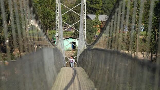 View of people walking on a suspension bridge in Surkhet Nepal.