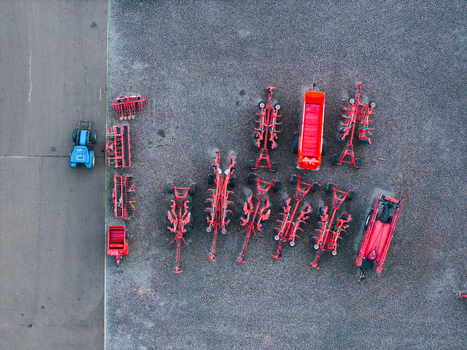 Aerial view of modern agricultural machinery including tractors and red farm implements parked at a sales and service center in Brankas Jelgava Municipality Latvia. Aerial view of modern agricultural machinery including tractors and red farm implements parked at a sales and service center in Brankas Jelgava Municipality Latvia.