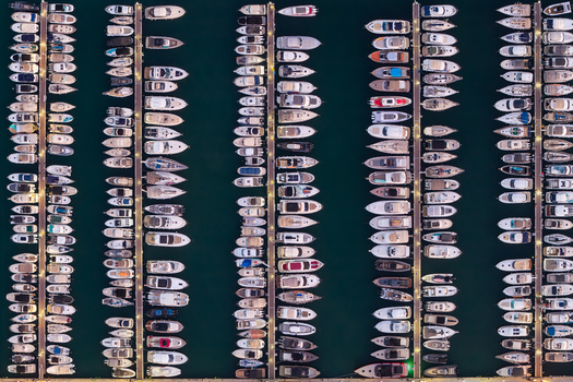 Aerial view of numerous yachts and boats docked in neat rows at the marina in Antibes Provence Alpes Cote d Azur France. Aerial view of numerous yachts and boats docked in neat rows at the marina in Antibes Provence Alpes Cote d Azur France.