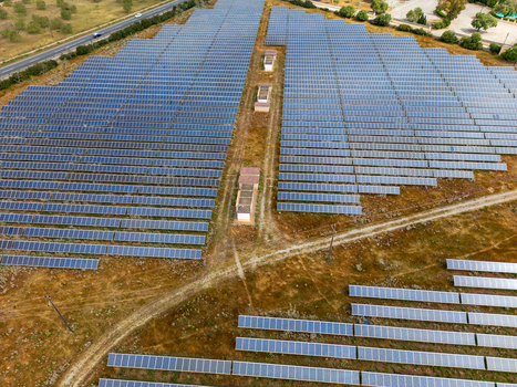 Aerial view of a large solar panel farm with rows of blue photovoltaic modules in a dry rural landscape Manacor Balearic Islands Spain. Aerial view of a large solar panel farm with rows of blue photovoltaic modules in a dry rural landscape Manacor Balearic Islands Spain.