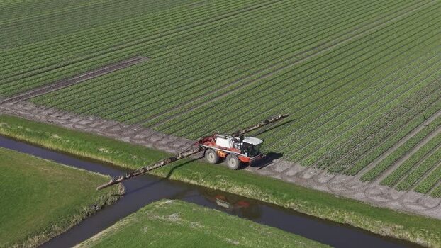 Aerial view of tractor spraying crops Opmeer North Holland Netherlands. Aerial view of tractor spraying crops Opmeer North Holland Netherlands.