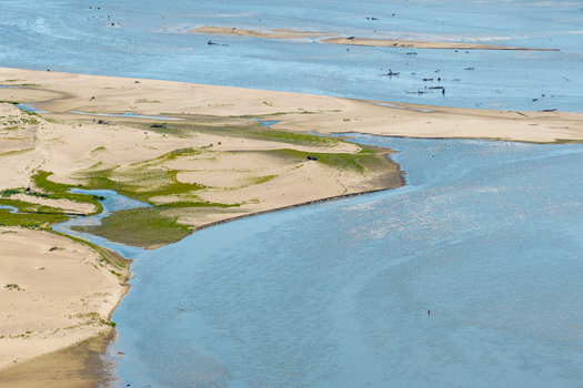 Aerial view of Zawadowskie Islands Nature Reserve with sandy riverbanks shallow water channels and green vegetation along the Vistula River in Kutno Masovian Voivodeship Poland. Aerial view of Zawadowskie Islands Nature Reserve with sandy riverbanks shallow water channels and green vegetation along the Vistula River in Kutno Masovian Voivodeship Poland.