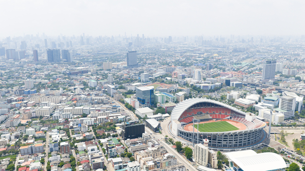 Aerial view of Rajamangala National Stadium surrounded by the dense urban landscape and high rise buildings of Krung Thep Maha Nakho Thailand. Aerial view of Rajamangala National Stadium surrounded by the dense urban landscape and high rise buildings of Krung Thep Maha Nakho Thailand.
