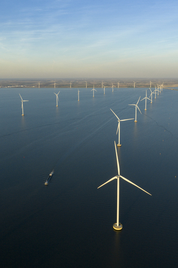 Aerial view of an offshore wind farm with rows of white turbines standing in calm blue water under a clear sky Netherlands. Aerial view of an offshore wind farm with rows of white turbines standing in calm blue water under a clear sky Netherlands.