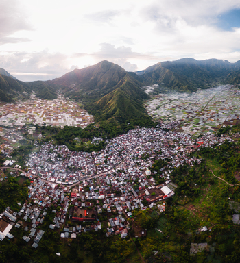 Aerial view of the Sembalun agricultural basin at the foothills of Mount Rinjani featuring terraced fields and village settlement in Sembalun West Nusa Tenggara Indonesia. Aerial view of the Sembalun agricultural basin at the foothills of Mount Rinjani featuring terraced fields and village settlement in Sembalun West Nusa Tenggara Indonesia.