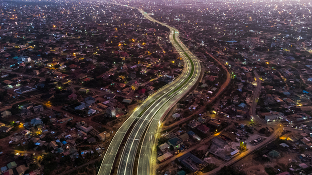 Aerial view of the illuminated Pokuase Interchange at night featuring multi level highway lanes winding through the urban landscape of Ga North Municipal Greater Accra Region Ghana. Aerial view of the illuminated Pokuase Interchange at night featuring multi level highway lanes winding through the urban landscape of Ga North Municipal Greater Accra Region Ghana.