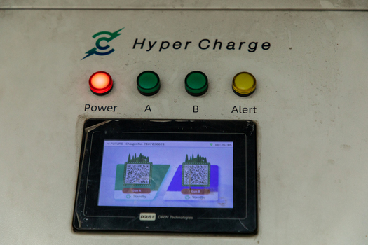 Pokhara Nepal 31 July 2026 View of the Hyper Charge electric vehicle charging station control panel with indicator lights and a digital screen displaying QR codes for charging guns.