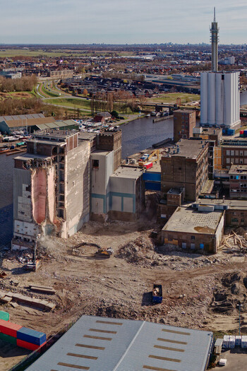 Aerial view of the skeletal remains of the Meneba Flour Mill against the distant Wormerveer cityscape a stark contrast of destruction and enduring urbanity Wormerveer Netherlands. Aerial view of the skeletal remains of the Meneba Flour Mill against the distant Wormerveer cityscape a stark contrast of destruction and enduring urbanity Wormerveer Netherlands.