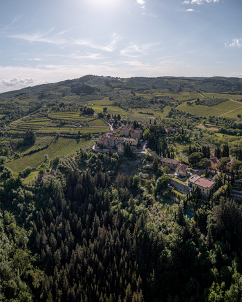 Aerial view of the historic fortified village of Montefioralle surrounded by lush vineyards olive groves and dense forests in Montefioralle Tuscany Italy. Aerial view of the historic fortified village of Montefioralle surrounded by lush vineyards olive groves and dense forests in Montefioralle Tuscany Italy.