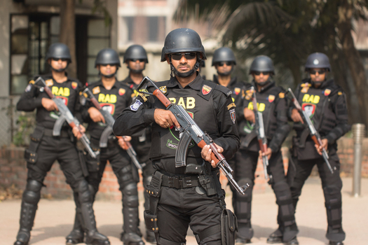 Dhaka Bangladesh 06 January 2017 View of Rapid Action Battalion RAB officers in black tactical uniforms and helmets holding rifles at the RAB Headquarters. Dhaka Bangladesh 06 January 2017 View of Rapid Action Battalion RAB officers in black tactical uniforms and helmets holding rifles at the RAB Headquarters.