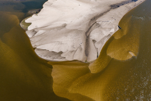 Aerial view of a large sandbank in a river caused by low water levels in Poland.