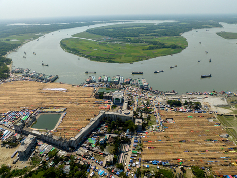 Aerial view of a bustling river port where boats meet land a symphony of commerce and transport Charmonai Barisal Division Bangladesh. Aerial view of a bustling river port where boats meet land a symphony of commerce and transport Charmonai Barisal Division Bangladesh.