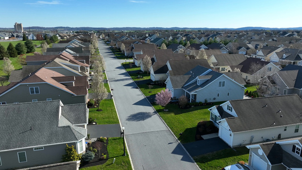 Aerial view of a suburban neighborhood with residential houses green lawns and blooming trees in Mount Joy Pennsylvania United States.