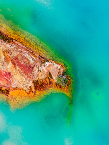Aerial view of a colorful peninsula with mineral rich soil and vibrant turquoise water in Andalusia Spain. Aerial view of a colorful peninsula with mineral rich soil and vibrant turquoise water in Andalusia Spain.