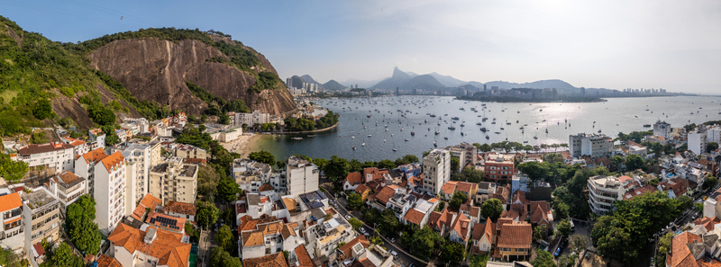 Aerial view of Urca neighborhood and Guanabara Bay with boats anchored in the water and Corcovado mountain in the distance Rio de Janeiro State of Rio de Janeiro Brazil.
