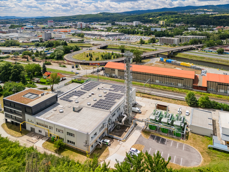 Aerial view of the STEFE Banska Bystrica heating plant featuring solar panels a tall chimney and industrial infrastructure in Banska Bystrica Banskobystricky kraj Slovakia. Aerial view of the STEFE Banska Bystrica heating plant featuring solar panels a tall chimney and industrial infrastructure in Banska Bystrica Banskobystricky kraj Slovakia.