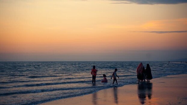 View of people on the beach at sunset in Cox s Bazar Bangladesh.