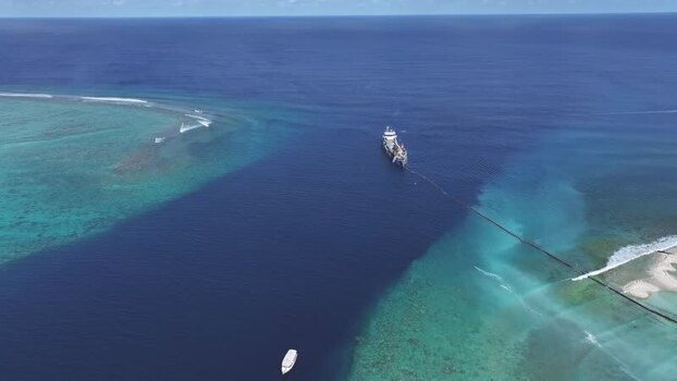 Aerial view of a large ship in a deep blue channel Maldives.