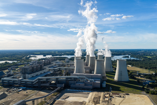 Aerial view of the Janschwalde Power Station with its large cooling towers emitting steam surrounded by industrial infrastructure and surrounding landscape in Peitz Brandenburg Germany. Aerial view of the Janschwalde Power Station with its large cooling towers emitting steam surrounded by industrial infrastructure and surrounding landscape in Peitz Brandenburg Germany.