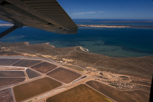 Aerial view of salt production ponds with geometric shapes and varied colors near the coastline in Kalbarri Western Australia Australia. Aerial view of salt production ponds with geometric shapes and varied colors near the coastline in Kalbarri Western Australia Australia.
