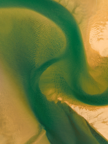 Aerial view of the winding emerald river snaking through the golden sand a mesmerizing dance of nature s artistry Rauðisandur Iceland. Aerial view of the winding emerald river snaking through the golden sand a mesmerizing dance of nature s artistry Rauðisandur Iceland.