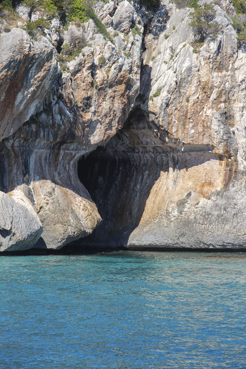 View of the sea cave at the Gulf of Orosei with turquoise water and rocky cliffs in Italy. View of the sea cave at the Gulf of Orosei with turquoise water and rocky cliffs in Italy.