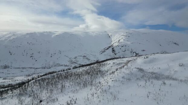 Aerial view of snow covered mountains on Kvaloya island Norway.