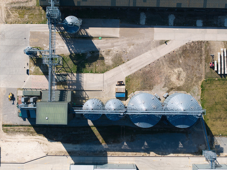 Aerial view of the Oat Milling Factory featuring large silver silos and industrial conveyor systems in Kettering England United Kingdom. Aerial view of the Oat Milling Factory featuring large silver silos and industrial conveyor systems in Kettering England United Kingdom.