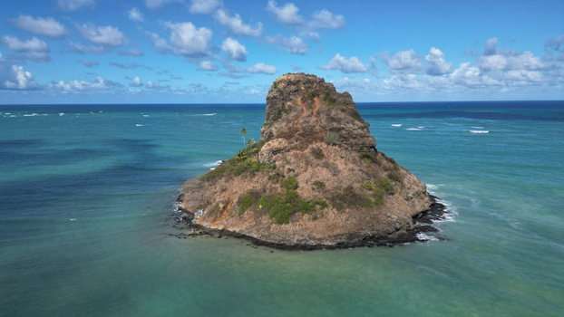 Aerial view of Chinaman s Hat Island a basalt islet with steep cliffs contrasts against the turquoise ocean Kaneohe Hawaii United States. Aerial view of Chinaman s Hat Island a basalt islet with steep cliffs contrasts against the turquoise ocean Kaneohe Hawaii United States.