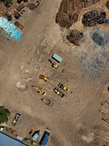Aerial view of Leyden construction site featuring heavy machinery including excavators and loaders on dirt ground with building materials in Jefferson County Colorado United States. Aerial view of Leyden construction site featuring heavy machinery including excavators and loaders on dirt ground with building materials in Jefferson County Colorado United States.