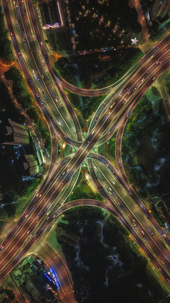 Aerial view of the Yan an East Road Interchange at night with illuminated traffic lanes and surrounding city lights in Shanghai Shanghai China. Aerial view of the Yan an East Road Interchange at night with illuminated traffic lanes and surrounding city lights in Shanghai Shanghai China.