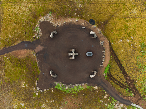 Aerial view of Arctic Henge with its stone structures arranged in a circular formation surrounded by mossy green landscape Raufarhofn Nordurthing Iceland.