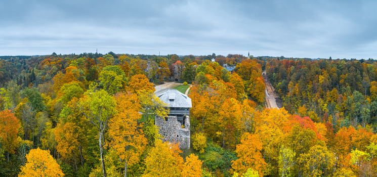 Aerial view of Sigulda Castle surrounded by vibrant autumn foliage in the Gauja Valley in Sigulda Sigulda Municipality Latvia. Aerial view of Sigulda Castle surrounded by vibrant autumn foliage in the Gauja Valley in Sigulda Sigulda Municipality Latvia.