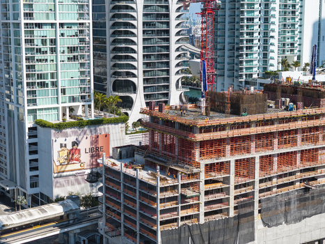 Aerial view of the towering cityscape with ongoing construction projects juxtaposed against modern architecture a dynamic blend of progress and urban life Miami Florida USA. Aerial view of the towering cityscape with ongoing construction projects juxtaposed against modern architecture a dynamic blend of progress and urban life Miami Florida USA.