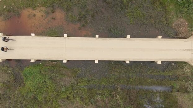 Aerial view of cyclists on a bridge in South Africa. Aerial view of cyclists on a bridge in South Africa.