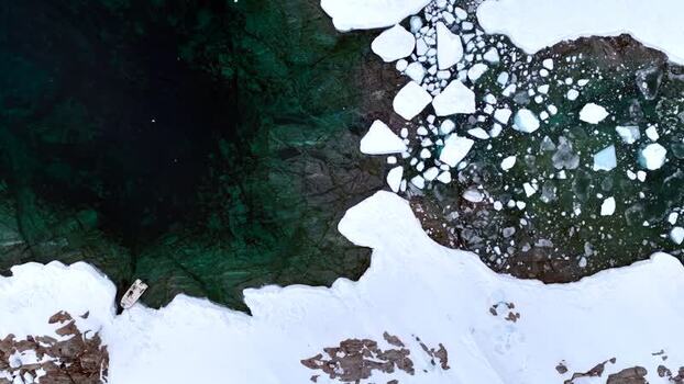 Aerial view of a boat navigating through ice floes Greenland. Aerial view of a boat navigating through ice floes Greenland.