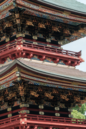 View of the weathered multi tiered pagoda with its intricate carvings and red lacquered details reaching towards the sky Narita Chiba Japan. View of the weathered multi tiered pagoda with its intricate carvings and red lacquered details reaching towards the sky Narita Chiba Japan.